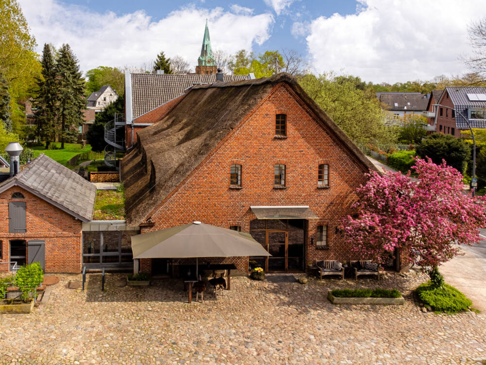 In dem traditionellen Klinkerbau mit Reetdach befinden sich ein kleines Boutique-Hotel und das Hygge / ©Landhaus Flottbek