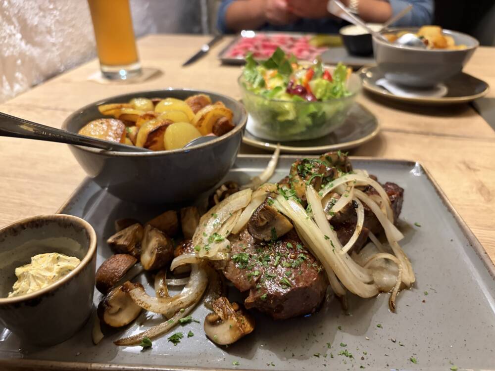 Herzhaft, deftig, genau richtig: saftiges Fleisch mit Röstkartoffeln, Zwiebeln und Pilzen / ©Michael Hein